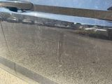 a close up of a car door handle with a sticker on it