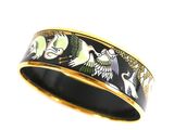 a close up of a black and gold ring with birds on it
