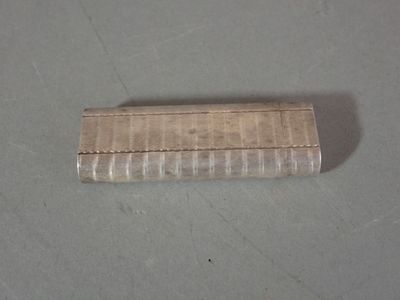 a small silver cigarette case sitting on a table