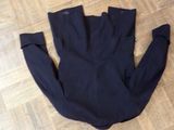 navy blue dress pants laying on the floor on a wooden floor