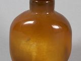 a brown glass bottle with a brown lid
