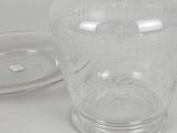 a clear glass vase with a lid on a table