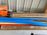 a pile of blue pipes sitting on top of a pallet