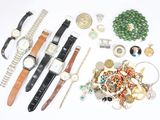 many different watches and bracelets laid out on a table