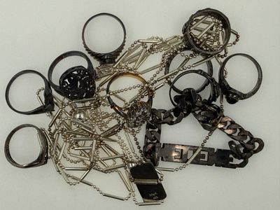 a pile of assorted metal items on a white surface