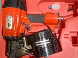 a red case with a stapler and a stapler in it