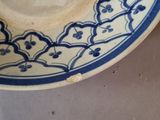 a blue and white plate with a chinese writing on it