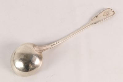 silver plated spoon with a spoon handle on a white surface