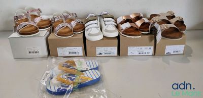 several pairs of shoes are lined up in a row on a table