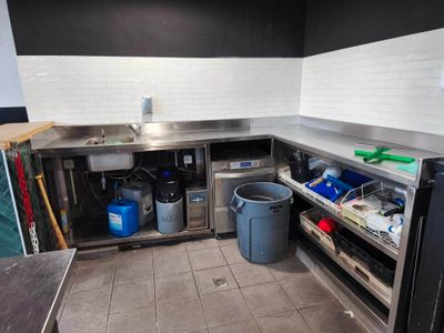 a kitchen with a sink and a refrigerator in it