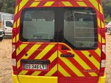 a yellow and red van parked in a lot