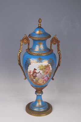 a blue vase with a painting on it sitting on a table
