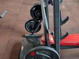 a gym with a bench, weights, and other equipment in it