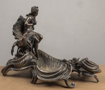 a statue of a woman sitting on top of a chair