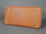 an image of a tan leather wallet with a zipper on the front