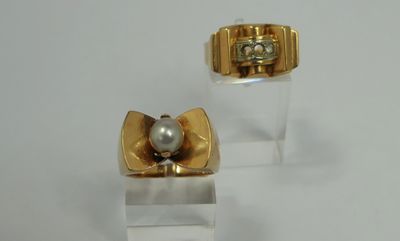 pair of gold and pearl earrings on clear acrylic stand