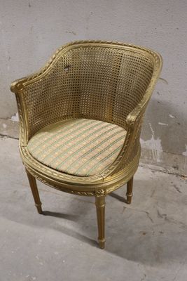 a wicker chair with a striped cushion on it