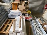 a lot of boxes and pallets in a storage area