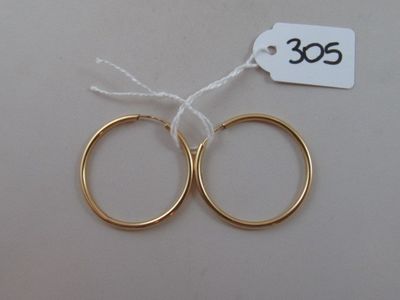 two pairs of gold hoop earrings with a price tag on a white background