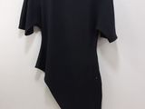 a black top hanging on a wall with a hanger