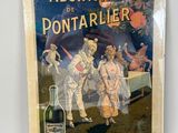un vieux livre sur lequel figure la photo d'un couple et d'une bouteille de vin