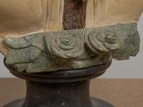 a bust of a man with a cross on his head