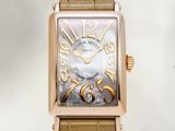 a gold watch with a brown leather strap on a white background