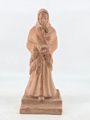statue of a woman holding a basket of flowers on a wooden base