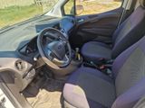 the interior of a small car with a steering wheel and a dashboard