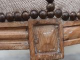 a close up of a wooden cross on a chair