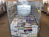 a large metal cage filled with magazines in a warehouse