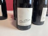 several bottles of wine are lined up on a table