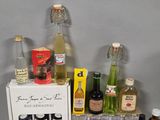 many bottles of alcohol on a shelf next to a box