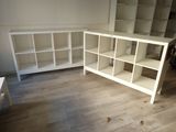 a white bookcase and a white desk in a room