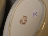 a close up of two white plates with brown designs on them