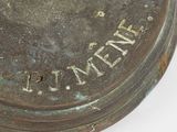 a close up of a metal object with writing on it