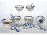 a group of blue and white bowls and spoons