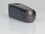 a close up of a metal object on a white surface