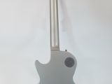 a guitar that is sitting on a stand on a white background