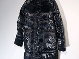the coat is shiny and shiny and has a hood on it