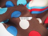 a brown scarf with blue and red polka dots on it