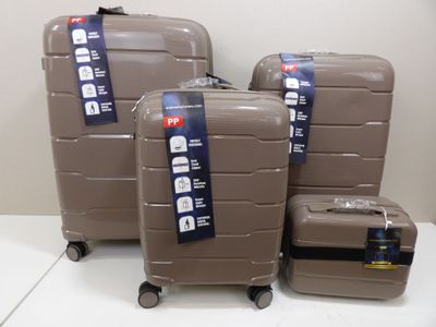 three pieces of luggage sitting on top of a white table