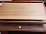 a wooden cutting board on top of a wooden table