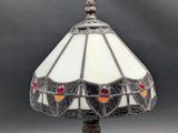 a close up of a lamp on a table with a gray background