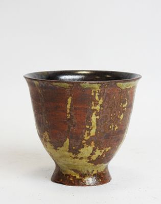 brown and black ceramic bowl on a white background
