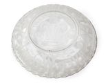 a glass plate with a crown on it on a white surface