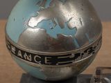 a silver and blue globe sitting on top of a table
