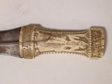 a knife with a carving on it sitting on a table