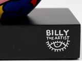 a colorful ball sitting on top of a black box