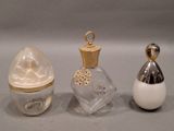 three perfume bottles sitting next to each other on a table